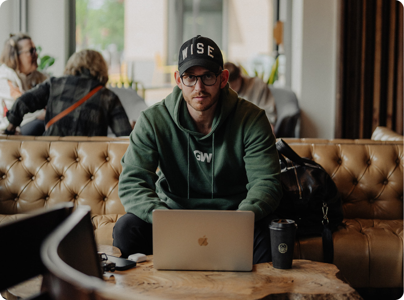 An image of Grant Wise sitting on a couch